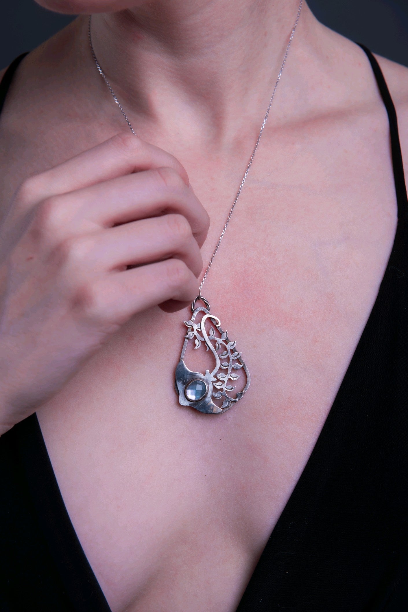 Layered sterling silver and textured seaweed stingray pendant and silvery blue amazonite doublet closeup